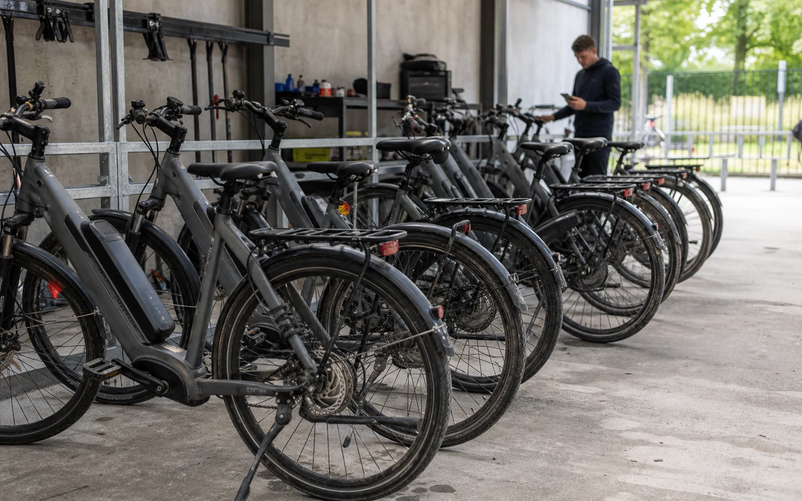 Organized e-bike rental fleet depot with maintenance and charging equipment